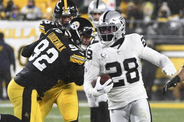 Las Vegas Raiders running back Josh Jacobs (28) carries the ball during the first half of an NFL football game against the Pittsburgh Steelers in Pittsburgh, Saturday, Dec. 24, 2022. (AP Photo/Fred Vuich)