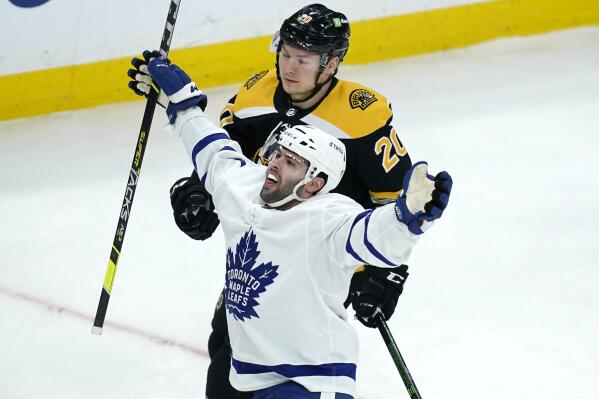 Toronto Maple Leafs center Colin Blackwell celebrates after his goal against Boston Bruins goaltender Jeremy Swayman during the first period of an NHL hockey game, Tuesday, March 29, 2022, in Boston. At rear is Boston Bruins center Curtis Lazar (20). (AP Photo/Charles Krupa)