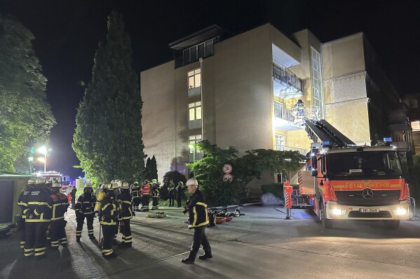 Firefighters with breathing apparatus and a ladder truck work at the Marienkrankenhaus hospital in Hamburg's Hohenfelde district of Hamburg, Germany Sunday, June 1, 2025. (Steven Hutchings/dpa via AP)