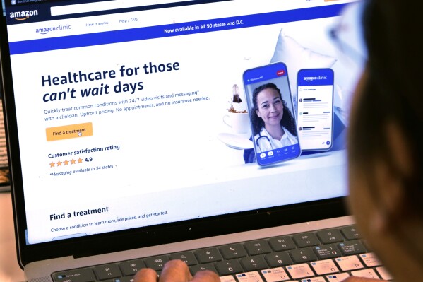 A page from Amazon's clinic site is shown on a laptop in New York on Tuesday, Aug. 1, 2023. Amazon is adding video telemedicine visits in all 50 states to the virtual clinic it launched last fall, as the e-commerce giant pushes deeper into care delivery. (AP Photo/Peter Morgan)