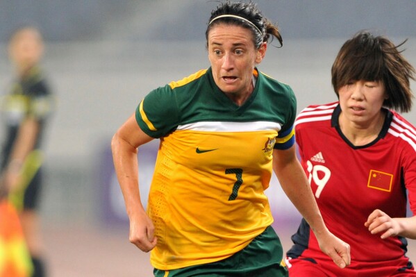 In this photo released by China's Xinhua news agency, Australia's Heather Garriock (7) vies with China's Zhou Feifei during their qualifying match of the 2012 Olympic women's soccer tournament in Jinan, China, Thursday, Sept. 8, 2011. (AP Photo/Xinhua, Xu Suhui, File)