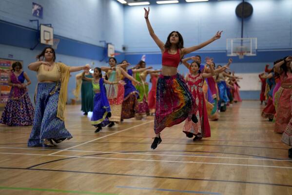 Performers take part in a rehearsal for the Nutkhut creative company ahead of their upcoming Bollywood style performance entitled "The Wedding Party", which will be part of the procession at the Platinum Jubilee Pageant, at Northolt High School, in north west London, Sunday, May 29, 2022. Celebrations will take place June 2-5 to mark Queen Elizabeth II's Platinum Jubilee, for her 70 years on the throne. (AP Photo/Matt Dunham)