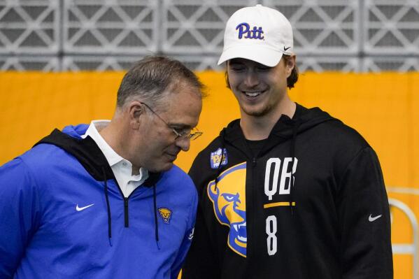 Pittsburgh head coach Pat Narduzzi, left, talks with quarterback Kenny Pickett (8 ) during Pittsburgh's football pro day Monday, March 21, 2022, in Pittsburgh. (AP Photo/Keith Srakocic)