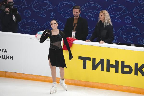 Russian Kamila Valieva, foreground, prepares to compete in the women's free skate program during the figure skating competition at the 2022 Russian Figure Skating Grand Prix, the Golden Skate of Moscow, as her coach Eteri Tutberidze, right, looks at her at Megasport Arena in Moscow, Russia, Sunday, Oct. 23, 2022. With its teams suspended from international competitions such as the Grand Prix series, Russia is holding its own series of figure skating events in various cities, also under the Grand Prix name. (AP Photo/Alexander Zemlianichenko)