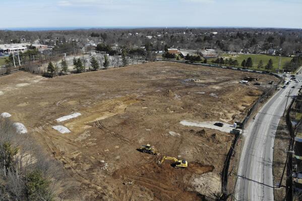A plot of land that is being developed into multifamily housing is seen in East Northport, N.Y., Thursday, March 16, 2023. Some elected officials from Long Island claim their suburban way of life is threatened by New York Gov. Kathy Hochul's plan to spur more housing construction. They claim it would swamp the area with new apartment buildings and turn it into a "sixth borough" of the city. (AP Photo/Seth Wenig)