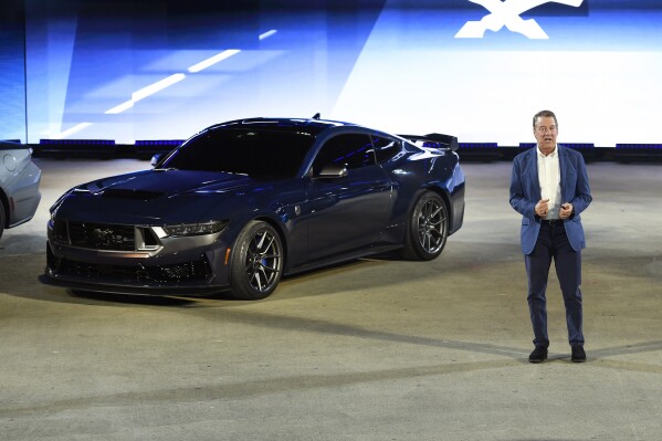 FILE - Bill Ford, executive chairman of Ford Motor Company, introduces one of the models of the 2024 Ford Mustang, the performance vehicle Dark Horse, at the North American International Auto Show, Wednesday, Sept. 14, 2022, in Detroit. New versions of the Mustang muscle car will begin shipping next week and more than two thirds of the orders include the big, 5-liter V-8 engine, Ford said Friday, Aug. 11, 2023. (AP Photo/Jose Juarez, File)