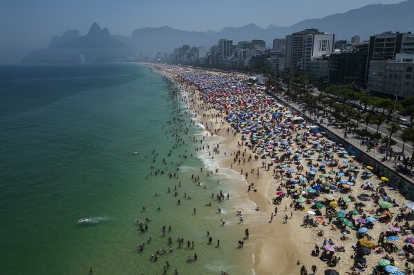 FILE - Beachgoers flock to Ipanema beach to beat the extreme heat in Rio de Janeiro, Brazil, Sept. 24, 2023. (AP Photo/Bruna Prado, File)