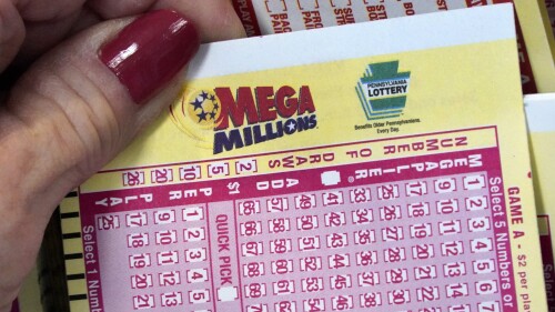 FILE - A Mega Millions wagering slip is held in Cranberry Township, Pa., Jan. 12, 2023. The huge $820 million Mega Millions jackpot up for grabs Tuesday, July 25, 2023, is the eighth-largest U.S. lottery prize.(AP Photo/Gene J. Puskar, File)