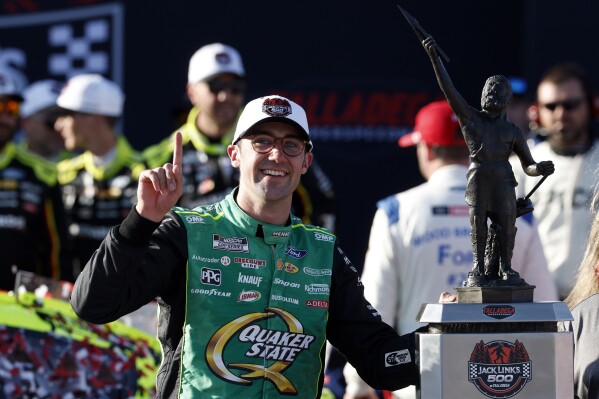 NASCAR Cup Series driver Austin Cindric celebrates after winning a NASCAR Cup Series auto race at Talladega Superspeedway, Sunday, April 27, 2025, in Talladega, Ala. (AP Photo/Butch Dill)