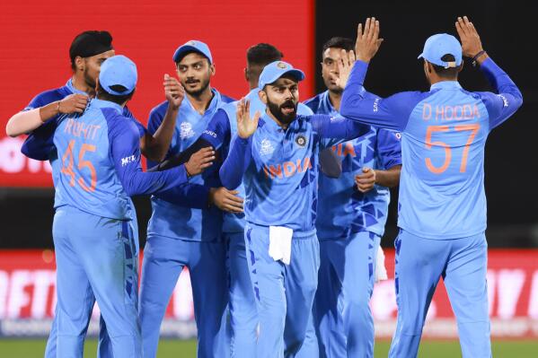 India's Virat Kohli gestures to teammate Deepak Hooda, right, following their T20 World Cup cricket match between India and Bangladesh in Adelaide, Australia, Wednesday, Nov. 2, 2022. India defeated Bangladesh by five runs. (AP Photo/James Elsby)