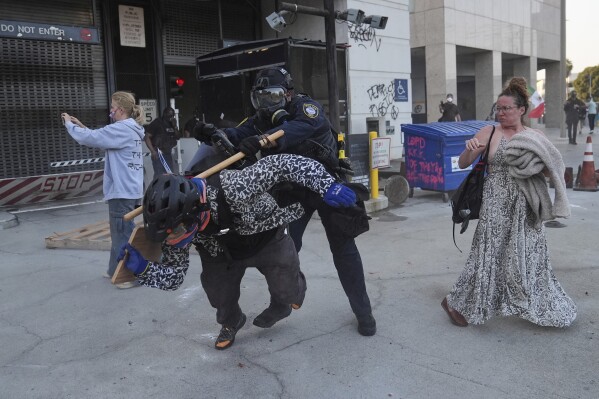A protester attempts to evade a Department of Homeland Security officer after federal immigration authorities conducted an operation on Friday, June 6, 2025, in Los Angeles. (AP Photo/Jae C. Hong)