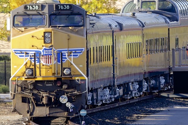 FILE - A Union Pacific locomotive with passenger cars in tow is parked, Oct. 17, 2013, in Omaha, Neb. Union Pacific's new CEO Jim Vena, who came into the job in August 2023 with a reputation for cost-cutting, says he won't shy away from that but no one should expect the kind of sweeping changes he made when he first oversaw the railroad's operations a few years ago. (AP Photo/Nati Harnik, File)