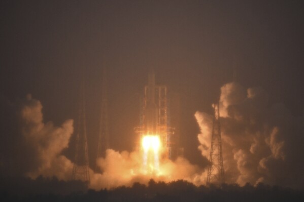 In this photo provided by China's Xinhua News Agency, a Long March-5 rocket, carrying the Chang'e-6 spacecraft, blasts off from its launchpad at the Wenchang Space Launch Site in Wenchang, south China's Hainan Province, Friday, May 3, 2024. China on Friday launched a lunar probe to land on the far side of the moon and return with samples that could provide insights into differences between the less-explored region and the better-known near side. (Guo Cheng/Xinhua via Ǻ)
