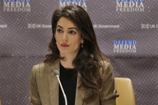 FILE - In this Wednesday, Sept. 25, 2019 file photo, attorney Amal Clooney listens during a panel discussion on media freedom at United Nations headquarters. British human rights lawyer Amal Clooney was named Friday Sept. 17, 2021, as one of 17 special advisers to the new chief prosecutor of the International Criminal Court. (AP Photo/Seth Wenig, File)