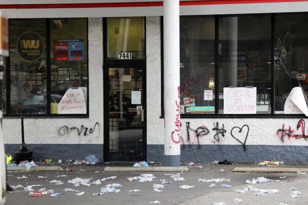 Debris is spread out in front of a convenience store, Tuesday, May 30, 2023, in Columbia, S.C. Richland County deputies said the store owner chased a 14-year-old he thought shoplifted, but didn't steal anything and fatally shot the teen in the back. (AP Photo/Jeffrey Collins)