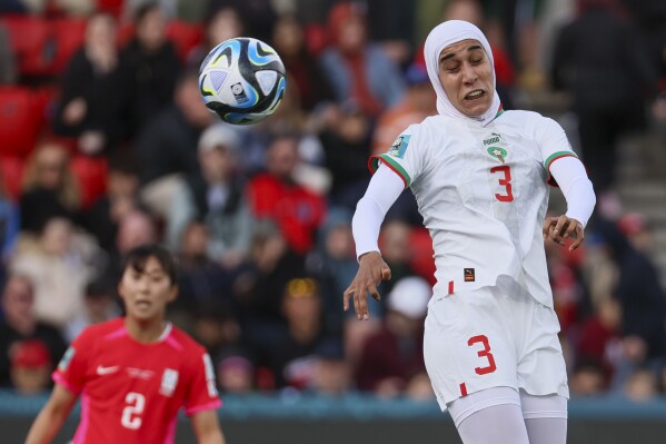 Morocco's Nouhaila Benzina heads the ball during the Women's World Cup Group H soccer match between South Korea and Morocco in Adelaide, Australia, Sunday, July 30, 2023. (AP Photo/James Elsby)