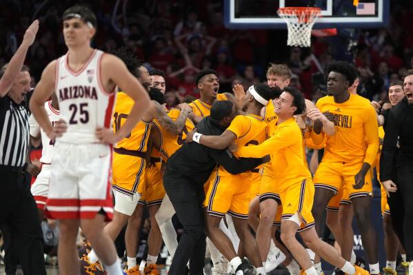 Arizona State guard Desmond Cambridge Jr. (4) celebrates with teammates after hitting a three point buzzer beater to defeat Arizona 89-88 during an NCAA college basketball game, Saturday, Feb. 25, 2023, in Tucson, Ariz. (AP Photo/Rick Scuteri)