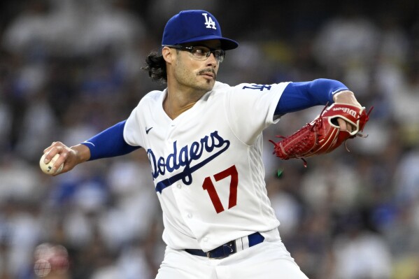 Los Angeles Dodgers relief pitcher Joe Kelly throws to a Cincinnati Reds batter during the sixth inning of a baseball game in Los Angeles, Saturday, July 29, 2023. (AP Photo/Alex Gallardo)