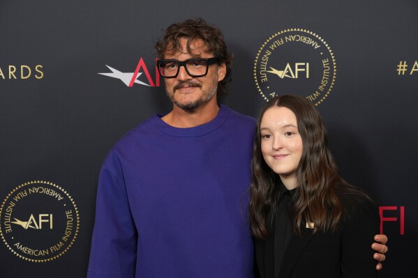 Pedro Pascal, left, and Bella Ramsey arrive at the AFI Awards on Friday, Jan. 12, 2024, at the Four Seasons Beverly Hills in Beverly Hills, Calif. (AP Photo/Chris Pizzello)
