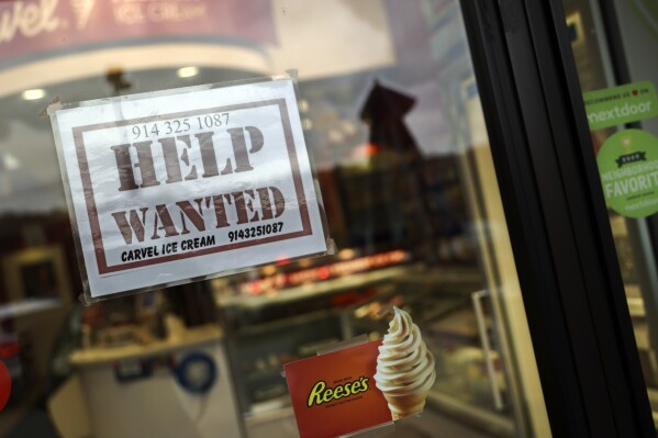 FILE — A help-wanted sign is posted in a storefront, Nov. 1, 2022, in Bedford, N.Y. Help-wanted advertisements in New York will have to disclose how much the jobs pay as a statewide salary transparency law goes into effect, Sunday, Sept. 17, 2023, part of growing state and city efforts to give women and people of color a tool to advocate for equal pay for equal work. (AP Photo/Julia Nikhinson, File)