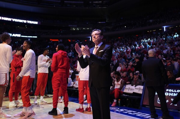 St. John head coach Rick Pitino, center, claps during the introduction of his players before an NCAA college basketball game against UConn, Sunday, Feb. 23, 2025, in New York. (AP Photo/Seth Wenig)