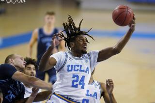 FILE - UCLA forward Jalen Hill grabs a rebound during the first half of the team's NCAA college basketball game against San Diego on Dec. 9, 2020, in Los Angeles. Hill, who played at UCLA for three seasons until leaving last year for personal reasons, has died, according to the university. He was 22. His family posted on Instagram that he had died after going missing in Costa Rica. No further details were provided. (AP Photo/Ashley Landis, File)