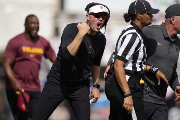 Southern California head coach Lincoln Riley, front left, yells at a referee for a call in the second half of an NCAA college football game against Colorado, Saturday, Sept. 30, 2023, in Boulder, Colo. (AP Photo/David Zalubowski)