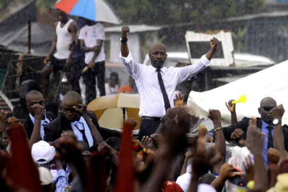 Ivory Coast's former youth minister Charles Ble Goude is cheered by supporters upon his return to Abidjan, Ivory Coast, Saturday Nov. 26, 2022, after more than a decade in exile. Ble Goude was acquitted of charges linked to the violence that erupted after the disputed 2010 election when then President Laurent Gbagbo refused to concede. ( AP Photo/ Diomande Bleblonde)