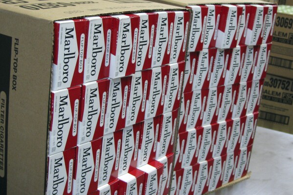 This July 29, 2013, photo shows a case of freshly-stamped Marlboro cigarette cartons at M. Amundson Cigar & Candy Co. in Minneapolis. Smokers in Minneapolis will pay some of the highest cigarette prices in the country after the City Council voted unanimously Thursday, april 25, 2024 to impose a minimum retail price of $15 per pack to promote public health. (Mark Zdechlik/Minnesota Public Radio via AP, file)