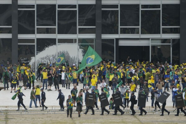 FILE - Protesters, supporters of Brazil's former President Jair Bolsonaro, storm the Supreme Court building in Brasilia, Brazil, Jan. 8, 2023. Brazil’s Supreme Court unanimously voted Monday, April 8, 2024, that the armed forces have no constitutional power to intervene in disputes between government branches, marking a largely symbolic decision aimed at bolstering democracy after years of increasing threat of military intervention.(AP Photo/Eraldo Peres, File)