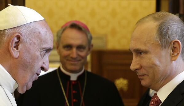 FILE - Pope Francis meets Russian President Vladimir Putin on the occasion of their private audience at the Vatican on June 10, 2015. Pope Francis went to the Russian Embassy on Friday, Feb. 25, 2022 to personally “express his concern about the war,” the Vatican said, in an extraordinary, hands-on papal gesture that has no recent precedent. Usually, popes receive ambassadors and heads of state in the Vatican, and diplomatic protocol would have called for the Vatican foreign minister to summon the ambassador. (AP Photo/Gregorio Borgia, Pool)