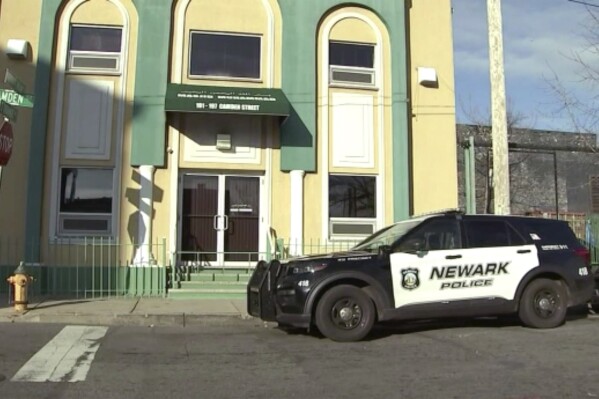 A Newark Police vehicle is parked outside the Masjid-Muhammad-Newark Mosque in Newark, N.J. on Wednesday, Jan. 3, 2024. A imam was shot and critically wounded early Wednesday morning outside the mosque as officers worked to identify and arrest the shooter. The victim was taken to nearby University Hospital and is in critical condition, authorities said. (WABC via AP)