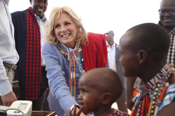 US first Lady Jill Biden, left, greets women of the Maasai community as they explain the drought situation in Ngatataek, Kajiado Central, Kenya, Sunday, Feb. 26, 2023. Biden is in Kenya on the second and final stop of her trip. (AP Photo/Brian Inganga)