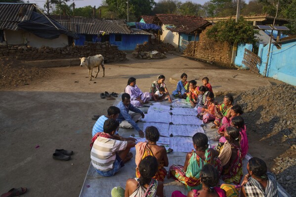 Members of Paroja Indigenous community discuss the maps they have made in Hatipakna village, Koraput district, in India's eastern state of Odisha, Thursday, April 17, 2025. (AP Photo/Rafiq Maqbool)