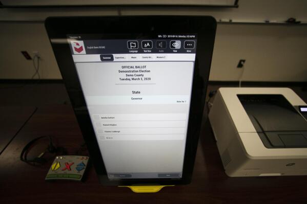 FILE - A sample ballot is shown using the Dominion Voting system Georgia will use, Sept. 16, 2019, in Atlanta, Ga. Testing before and after elections show the voting machines accurately tally the ballots, contradicting a relentless campaign of unfounded conspiracy theories that has undermined confidence in voting equipment throughout the U.S.  (AP Photo/John Bazemore, File)