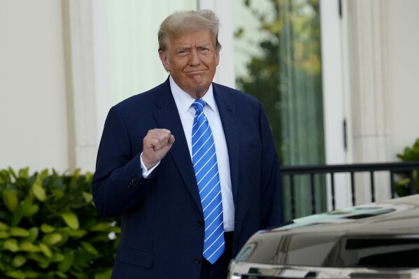 Former President Donald Trump pumps his fist as he arrives for a GOP fundraiser, Saturday, April 6, 2024, in Palm Beach, Fla. (AP Photo/Lynne Sladky)