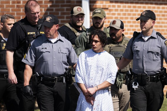 Law enforcement officers escort Danilo Cavalcante from a Pennsylvania State Police barracks in Avondale Pa., on Wednesday, Sept. 13, 2023. Cavalcante was captured Wednesday after eluding hundreds of searchers for two weeks. (AP Photo/Matt Rourke)