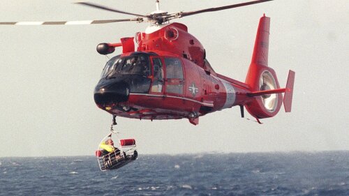 FILE - Balloonist Steve Fossett is retrieved by a U.S. Coast Guard helicopter from waters 10-15 miles north of the island of Oahu in the Hawaiian Islands, Dec. 25, 1998, after abandoning his quest along with Per Lindstrand, of Sweden, and British mogul Richard Branson, who were attempting to make the first nonstop round-the-world flight in a balloon. The massive hunt for the Titan submersible that imploded deep in the North Atlantic has refocused attention on whether wealthy risktakers should pay for emergency search and rescue efforts. (Richard Ambo/Honolulu Star-Advertiser via AP, File)