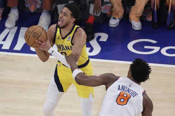 Indiana Pacers guard Tyrese Haliburton (0) is fouled by New York Knicks forward OG Anunoby (8) during the first quarter of Game 5 of the NBA basketball Eastern Conference final, Thursday, May 29, 2025, in New York. (AP Photo/Adam Hunger)