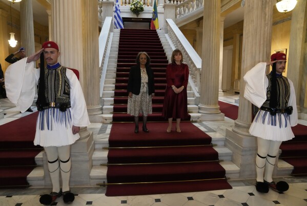 President of Ethiopia Sahle-Work Zewdein, left, and her Greek counterpart Katerina Sakellaropoulou pose for the photographers before their meeting at the Presidential Palace in Athens, Greece, Tuesday, March 19, 2024. Sahle-Work Zewdein is in Greece to attend the Women Political Leaders (WPL), the global network of women politicians summit which will take place from March 19 to 21 in the Greek capital. (AP Photo/Thanassis Stavrakis)