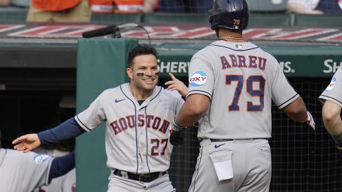 Houston Astros' Jose Altuve (27) greets Jose Abreu at the dugout after Abreu hit a home run in the first inning of a baseball game against the Cleveland Guardians, Saturday, June 10, 2023, in Cleveland. (AP Photo/Sue Ogrocki)