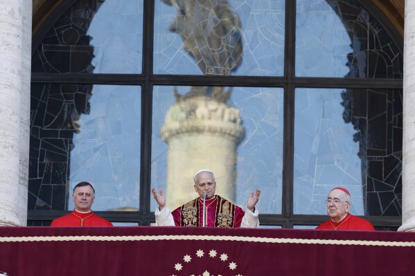 Pope Leo XIV appears from the balcony at the Basilica of St. Mary Major to take possession of the last of the four major papal basilicas that completes the symbolic and liturgical "taking possession" of the four basilicas that signify full papal authority within Rome, in Rome, Sunday, May 25, 2025. (AP Photo/Riccardo De Luca)