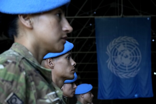 Soldiers serving with the United Nations peacekeeping force (UNFICYP) in ethnically-divided Cyprus stand during a parade marking the 60th anniversary of the force's inception, inside a U.N. controlled buffer zone that separates breakaway Turkish Cypriots in the north and Greek Cypriots in the internationally recognized south, on Monday, March 4, 2024. More than 150,000 peacekeepers from 43 countries have served with UNFICYP since 1964 with 187 soldiers and staff losing their lives while serving with the mission. (AP Photo/Petros Karadjias)