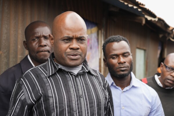 David Wangila, center, who believes his nephew Douglas Kalasinga was killed during one of the protests in July over new taxes and the rising cost of living, speaks to The Associated Press outside the city mortuary in Nairobi, Kenya, Friday, July 21, 2023. Data shared with the AP by a police watchdog, the Independent Medico-Legal Unit, showed 35 people killed by police across the country in such demonstrations this month. (AP Photo/ Khalil Senosi)