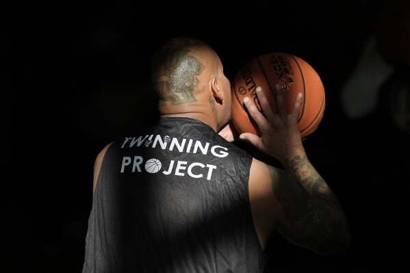 Daniel Lopez performs a basketball drill with other Twinning Project cohort 2 participants during the project's collaboration with the NBA's Golden State Warriors and the California Department of Corrections and Rehabilitation at Solano State Prison in Vacaville, Calif., Tuesday, Feb. 11, 2025. (AP Photo/Jeff Chiu)