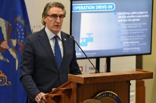 FILE - In this April 3, 2020 file photo, North Dakota Governor Doug Burgum, where  he announced a pilot project to identify positive cases of COVID-19 earlier to slow the spread of Coronavirus in North Dakota. Burgum is pleading for citizens to get vaccinated against the coronavirus as North Dakota's hospitals struggle to handle the influx of patients infected with the highly contagious delta variant. Burgum brought together health professionals from around the state Wednesday in his first COVID-19 briefing in more than five months. (Tom Stromme/The Bismarck Tribune via AP, file)