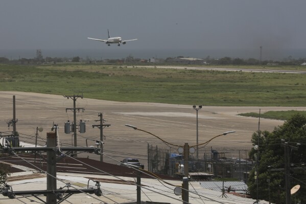 An Amerijet plane prepares to land as it arrives at the Toussaint Louverture International Airport in Port-au-Prince, Haiti, Monday, May 20, 2024. Haiti's main international airport reopened Monday for the first time in nearly three months after gang violence forced authorities to close it in early March. (AP Photo/Odelyn Joseph)