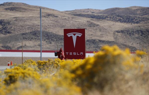 FILE - A sign marks the entrance to the Tesla Gigafactory, Oct. 13, 2018, in Sparks, Nev. Tesla will get more than $330 million in tax breaks from Nevada to massively expand its vehicle battery facility east of Reno and add a new electric semi-truck factory. Approval on Thursday, March 2, 2023, from the Governor's Office of Economic Development came as Republican Gov. Joe Lombardo cited the benefit of jobs and the boost that Tesla's huge Gigafactory has given the local economy for almost a decade. (AP Photo/John Locher, File)