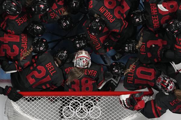 Canada's players huddle prior a women's quarterfinal hockey game between Canada and Sweden at the 2022 Winter Olympics, Friday, Feb. 11, 2022, in Beijing. (AP Photo/Petr David Josek)