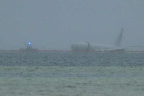 A downed U.S. Navy aircraft is seen in Kaneohe Bay, Monday, Nov. 20, 2023, in Kaneohe, Hawaii. (Jamm Aquino/Honolulu Star-Advertiser via AP)